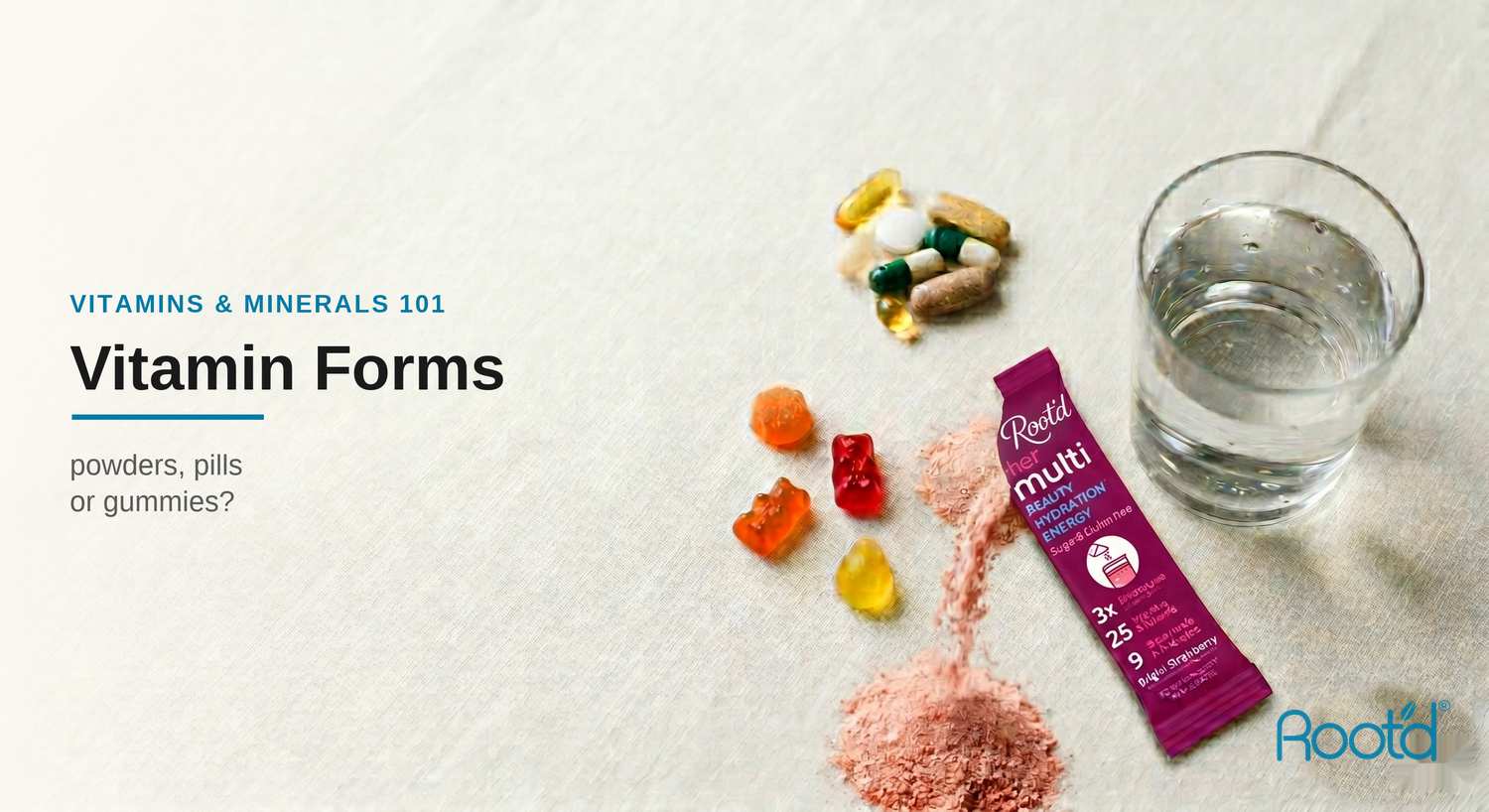 Pills, gummy vitamins and a torn Root'd Her MULTI Bright Strawberry stick pack with powder spilling beside a glass of water