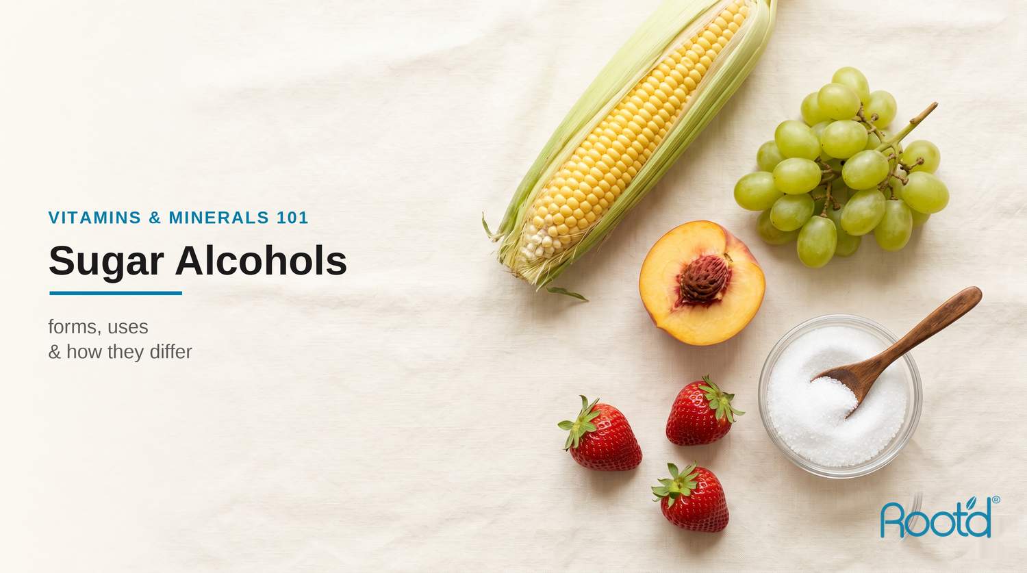 Whole foods that sugar alcohols come from — corn, grapes, peach, strawberries and white sweetener on a cream surface